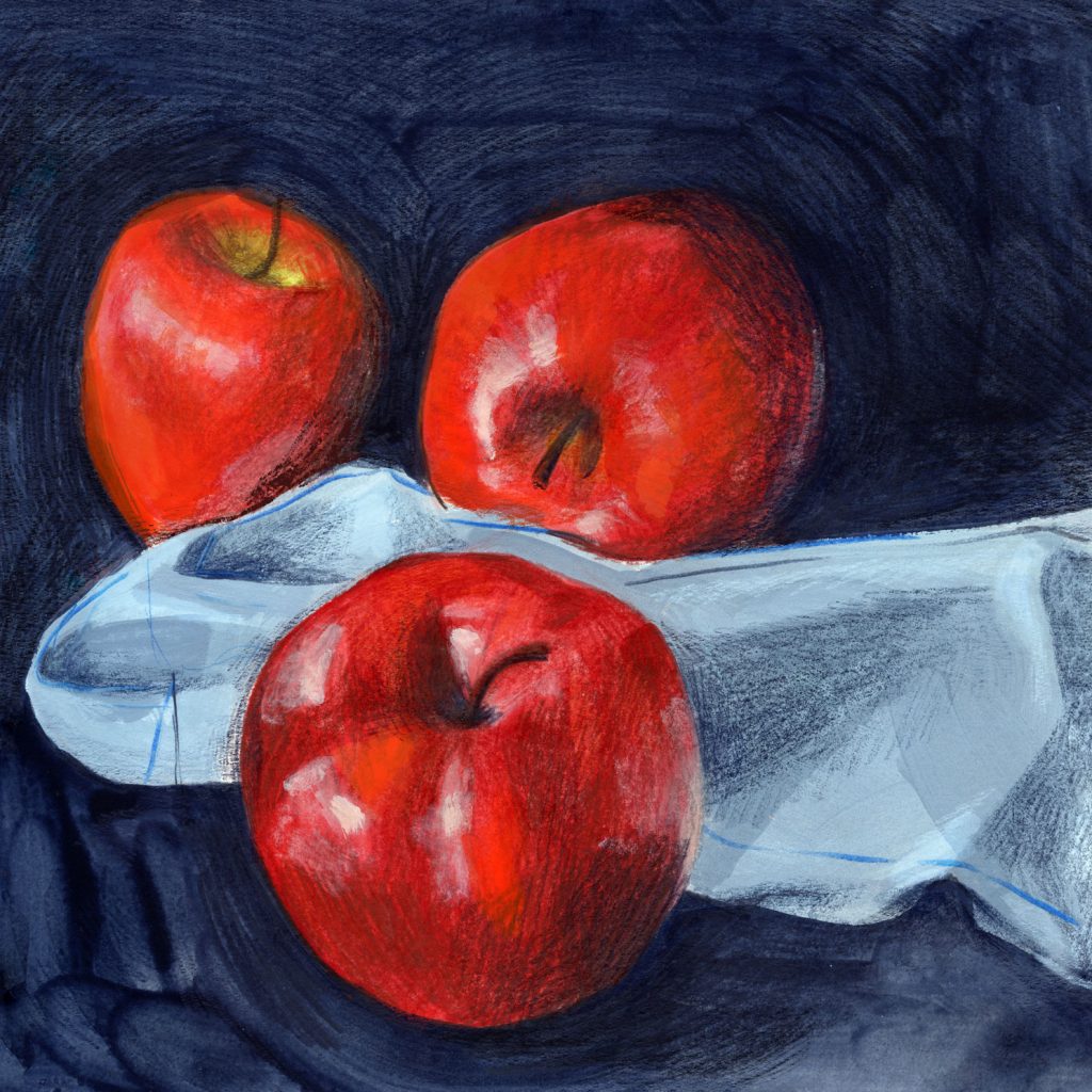 Three shiny red apples with a blue napkin on a dark background
